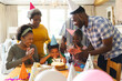 © Wavebreak Media - Happy african american family celebrating birthday, blowing candles