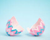 Fototapeta Nowy Jork - Pink and blue Easter egg open and cracked in half. Empty copy space for text or product.