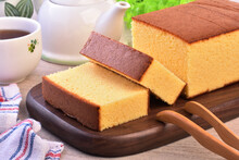 Castella (kasutera) - Delicious sliced honey sponge cake on wooden plate