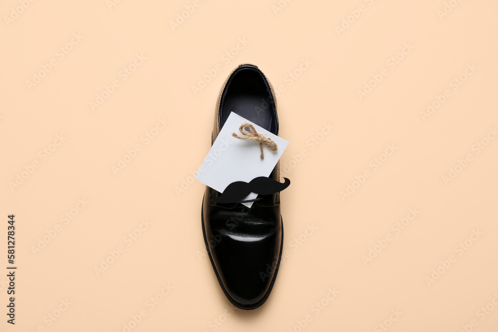 Blank card with paper mustache and shoe on beige background. Father's Day celebration