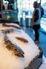 Whole fish displayed on a counter filled with ice and ready for sale, Mercado de San Miguel, Madrid.