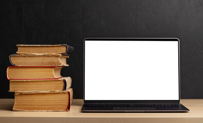 Wall Mural - Laptop and stack of books