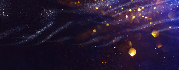 Wall Mural - background of abstract glitter lights. gold, blue and black. de focused