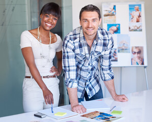 Poster - Working hard to reach their creative goals together. A young team of creatives at work.