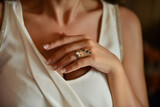 Fototapeta  - Bride hand wearing a diamond ring. Wedding accessories bride on the wedding day.