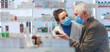© Halfpoint - Young pharmacist helping senior man to choos medication.