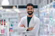 © Halfpoint - Portrait of young multiracial pharmacist looking at camera, standing in a pharmacy shop.