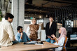 © Drobot Dean - Group of businesspeople having discussion while working together in office