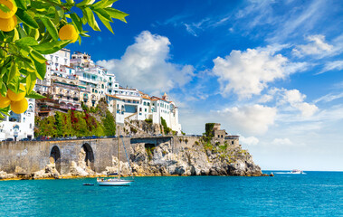 Beautiful view of Amalfi on the Mediterranean coast with lemons in the foreground, Italy