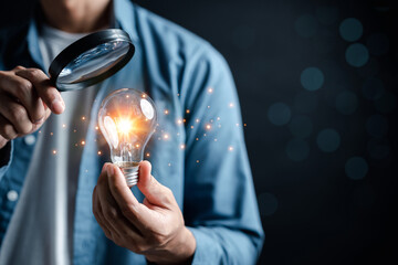 Fototapete - Businessman focus with magnifying to light bulb with business target planning idea and creativity innovation development leadership investment growth and success development, goal, strategy