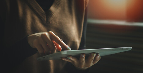 Fototapete - Woman's hands holding and using a digital tablet. business technology background. banner desing, IoT, internet of things.	