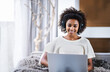 © Mapodile/peopleimages.com - No distance is too great with video chatting. a young woman wearing headphones sitting at home using a laptop.