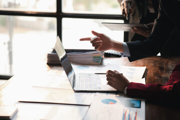 The sales department is having a monthly summary meeting to bring it to the department manager, they are verifying the correctness of the documents that are prepared before bringing in to the manager