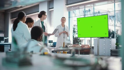 Aufkleber - Group of Students Listening to Their Robotics Female Professor Who Uses Green Screen Monitor in a Laboratory. Team of Engineers Having Meeting and Discussing Manufacturing Ideas, Using Technology