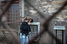 Young Girl Using The Old Abandoned Phone Booths Of The Old Joliet Prison