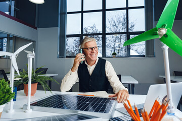 Wall Mural - Male mature architect working on an ecological construction project in office