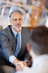 Canvas Print - Starting a new venture. A mature businessman shaking the hand of an unrecognizable person.