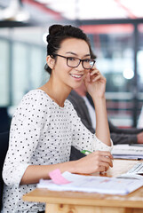 Poster - Make creativity a job. a young office worker sitting at her workstation in an office.