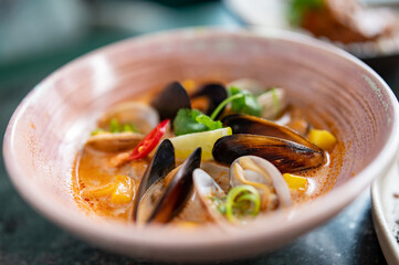 Wall Mural - bowl of hot and delicious seafood soup on table