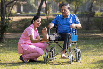 Senior man making physiotherapy session with young nurse.