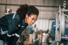 After Working For A Prolonged Period Of Time, A Black Female Robotic Welding Technician Experiences Feelings Of Exhaustion, Tiredness, And Burnout. The Tension Caused By The Pressure Of Routine Work