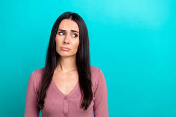 Wall Mural - Photo of unsatisfied gloomy person look empty space sad sullen face isolated on turquoise color background