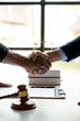 © crizzystudio - Legal and justice concept Young asian businessman shaking hands with young lawyer or legal advisor after contracting business partnership agreement in real estate project and finance in the office.