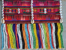Bright Ethnic Fabrics Are Embellished With Colorful Beads And Silver Metal. Long String Of Colorful Small Beads To Decorate Bags, Clothes Or Other Decorations. Lines Of Plastic Beads Black, White, Red