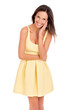 What could be more feminine than a summer dress. Studio portrait of a beautiful young woman posing in a yellow dress.