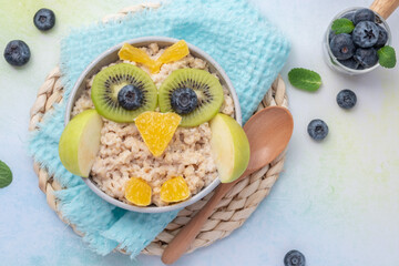 Wall Mural - Kids breakfast porridge look like cute owl with fruits and nuts