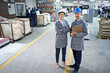 © Yuri A for PeopleImages/peopleimages.com - From printing to packaging, we can do it all. Portrait of two managers standing inside a printing and packaging plant.
