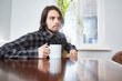 © Татьяна Кутина - A cup in the hands of a young man. Focus on the cup