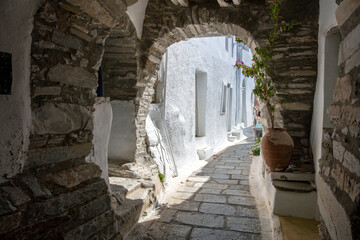 Wall Mural - Tinos island Greece. Kardiani village, arched stonewall cover narrow cobblestone alley