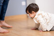 © ADDICTIVE STOCK - Little girl crawling on floor near crop parent