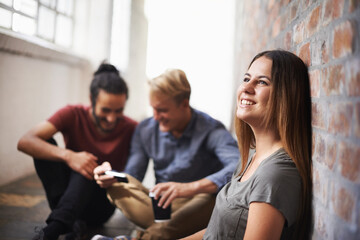 Sticker - Relaxing before the next class. students relaxing in a hallway.