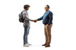 © Ljupco Smokovski - Full length profile shot of an african american male student and a mature man shaking hands