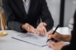 © SOMKID - lawyer working with contract agreement at table office, law and justice concept, Selective focus.
