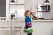 © Olena - Child cleans at home concept. Kid cleaning with mop to help with housework. Little cute boy sweeping and cleaning, on kitchen background.