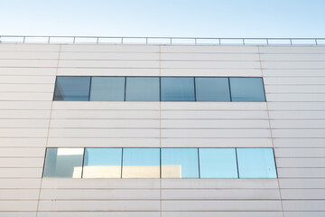 Poster - Urban contemporary arcitecture. Close up of a modern office building with windows
