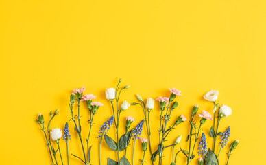 flowers composition on a bright yellow trendy background. floral background. backdrop for mother’s d