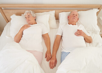 Canvas Print - Lifetime of togetherness. High angle shot of a senior couple asleep in bed.