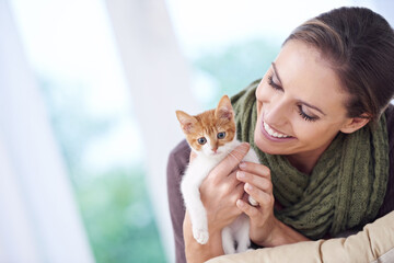 Poster - Happy is the one who owns a cat. an attractive young woman holding a kitten.