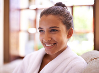 Wall Mural - Her mood was instantly brightened. a young woman in a bathrobe at a health spa.