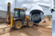 CCTV camera watching an excavator and workers working on a construction site.