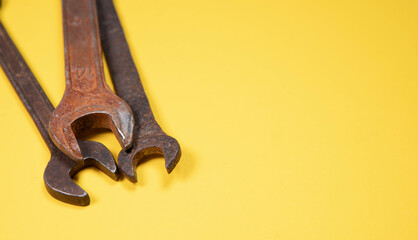 Old wrenches on a yellow background metal and rusty wrench isolated on yellow background.An old rusty wrench on a white background. Vintage wrench close-up.