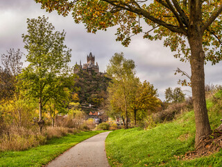 Wall Mural - Cochem castle, colourful autumn trees and pedestrian pathway in Cochem-Zell district, Germany