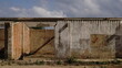 abandoned rural warehouse in empty field