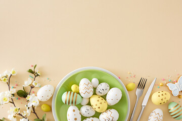 easter decor concept. top view composition of green plate with colorful eggs cutlery fork knife cook