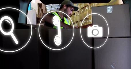 Poster - Animation of network of icons over caucasian man loading car with boxes, working in warehouse