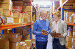 © Yuri Arcurs/peopleimages.com - Checking shipments. a man and woman inspecting inventory in a large distribution warehouse.